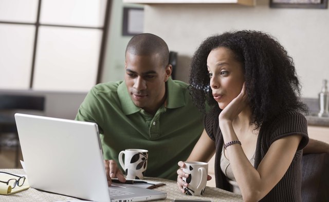 Couple at home on laptop computer