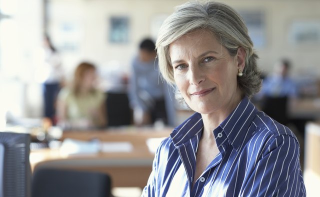 Mature businesswoman in office, portrait, close-up