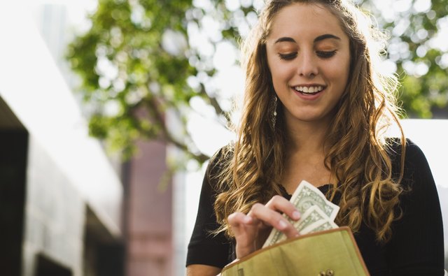 Teen removing money from wallet