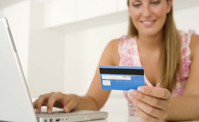 Woman with credit card and laptop