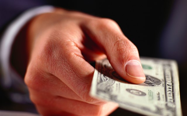 Hand Holding a Twenty Dollar Bill