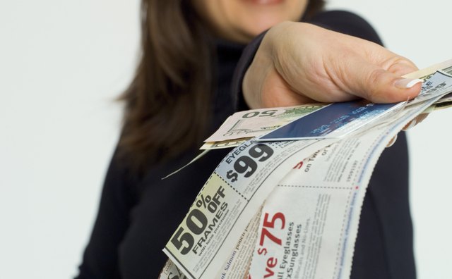 Woman with coupons, credit card and money
