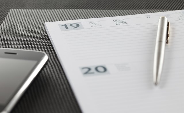 Close-up on an open agenda and modern smart phone.
