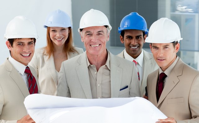 Architects with hardhats in a building site