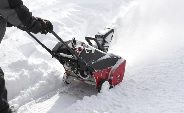 Man removing snow after storm with a snowblower