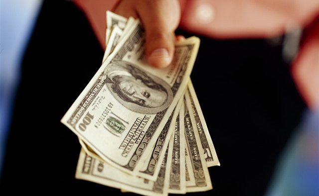Hand with American dollars