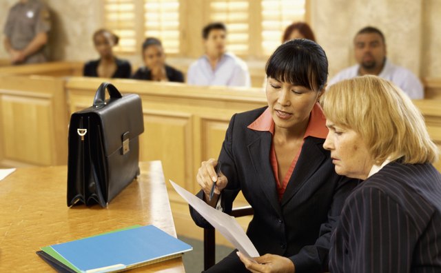 Side profile of a lawyer discussing the case with the witness