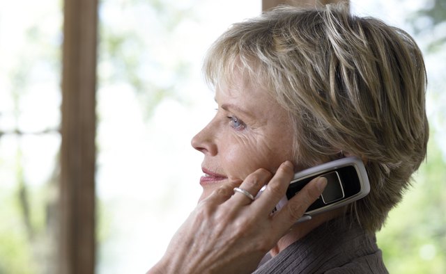 Mature woman using mobile phone, profile, close-up