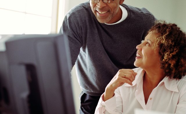 Mature couple working in home office