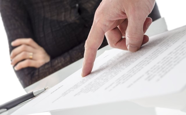 Hand showing a woman to sign the document