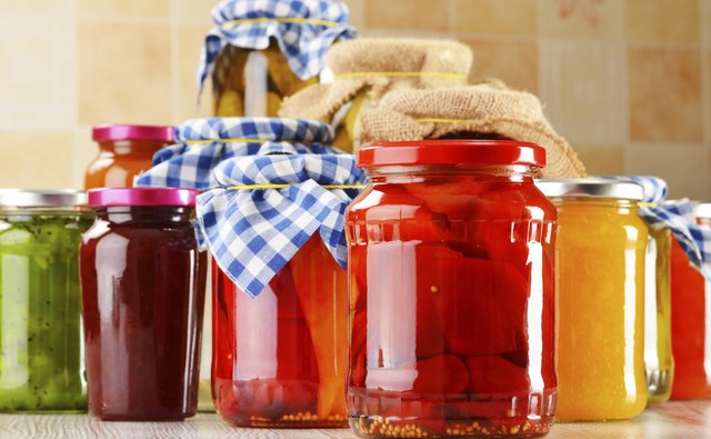 Jars of marinated food. Pickled vegetables and jams