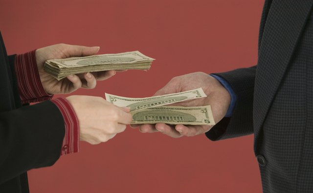Hands exchanging money