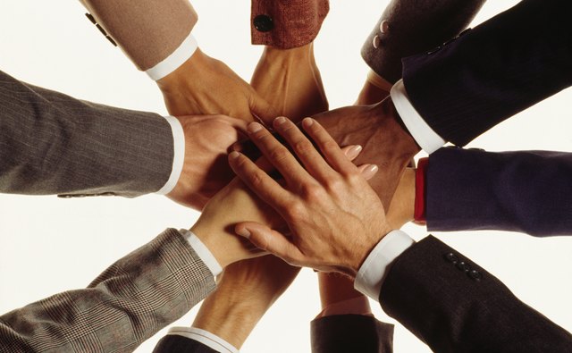 Hands of businesspeople in huddle