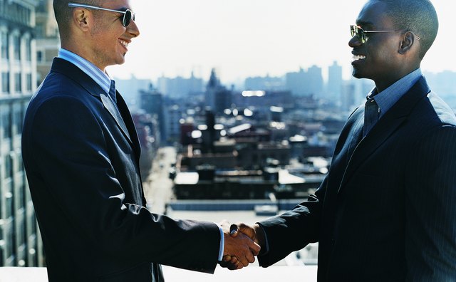 Businssmen Shaking Hands Outdoors on a City Balcony