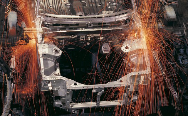 Robots assembling cars on production line
