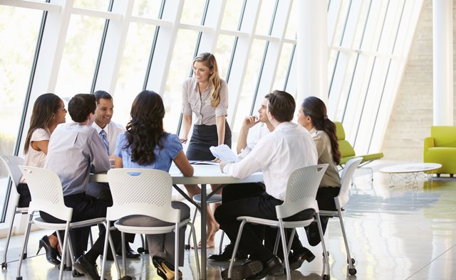 Business People Having Board Meeting In Modern Office