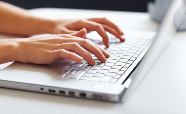 Businesswoman typing on laptop