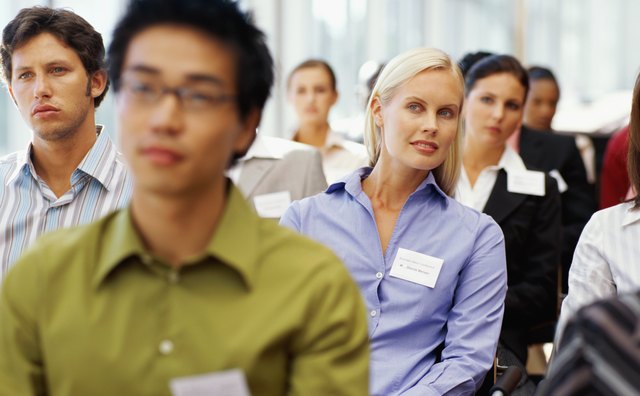 group of business executives sitting at a seminar