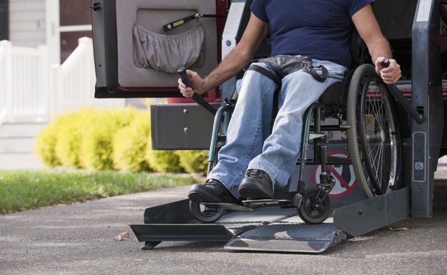 Man with spinal cord injury in a wheelchair getting in his accessible van