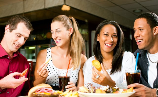 Friends eating hamburger and drinking soda