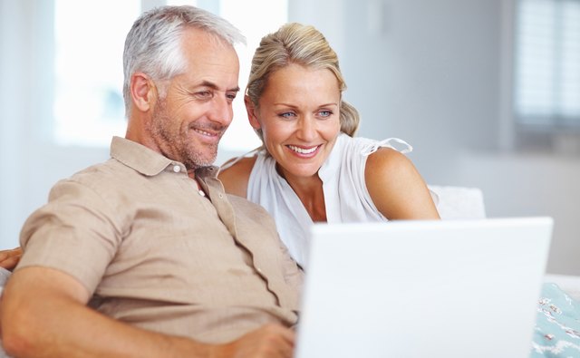 Mature couple using laptop at home