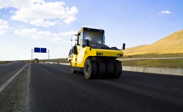 road roller leveling new fresh asphalt pavement