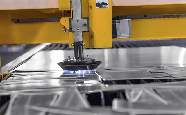 Machine cutting steel in a factory