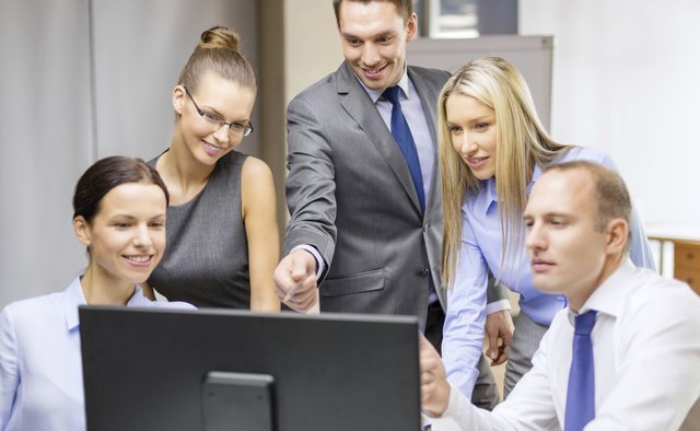 business team with monitor having discussion