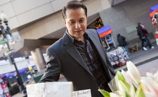 Hispanic businessman shopping flowers in a market
