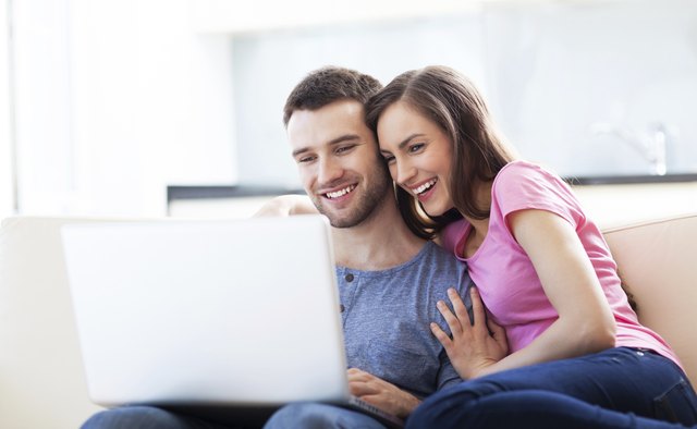 Couple on sofa with laptop