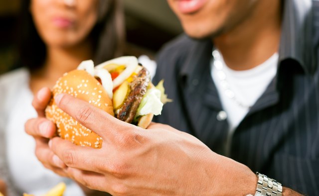 Man in a restaurant eating hamburger