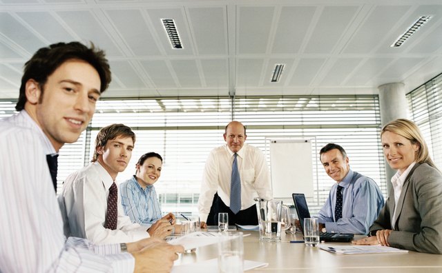 Portrait of a CEO With His Business Executive Team in a Boardroom Meeting