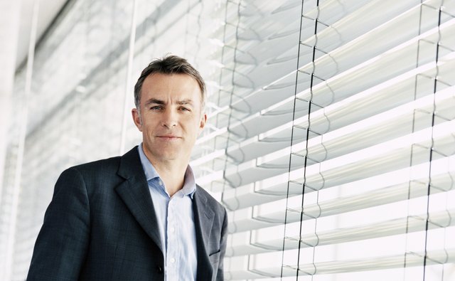Portrait of a CEO Standing by a Window