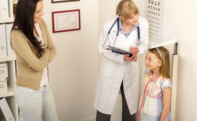 Medical check-up at pediatrist girl measure height
