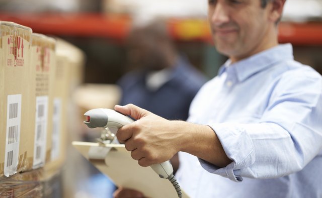 Worker Scanning Package In Warehouse