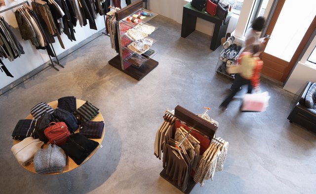 Man and woman exiting retail store, elevated view (blurred motion)