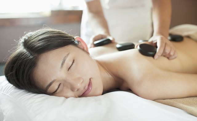 Young Woman Receiving Hot Stone Massage