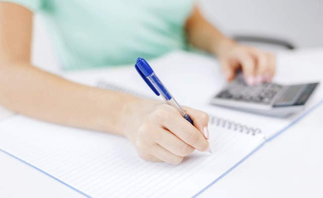 businesswoman working with calculator in office