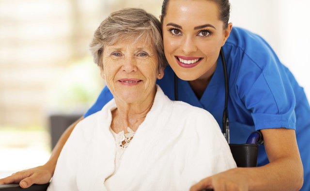 senior woman on wheelchair with caregiver