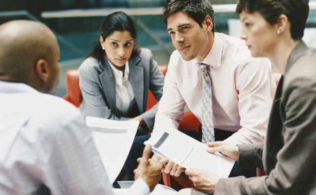 Business People Sitting in an Office Building Having a Meeting