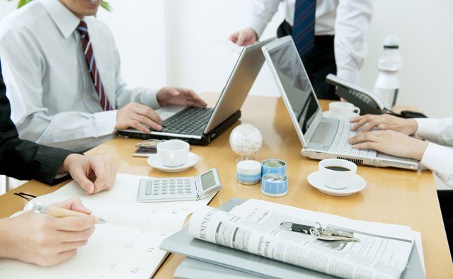 Colleagues working at desk in office