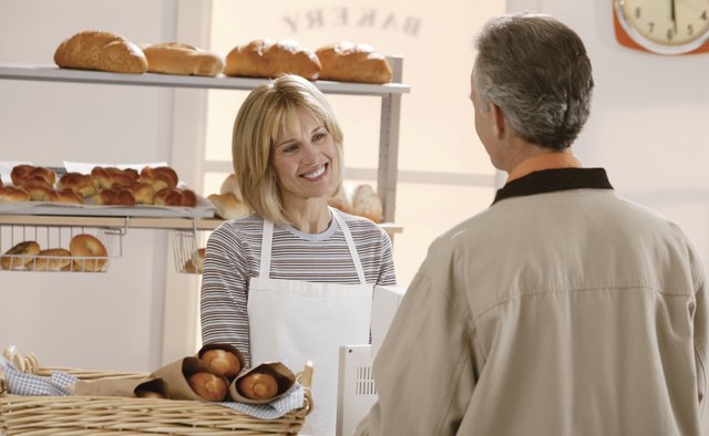 Woman talking to man in bakery