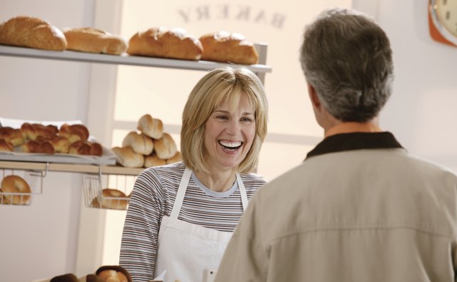 Woman talking to man in bakery