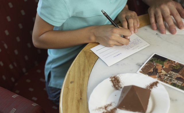 Woman writing postcards
