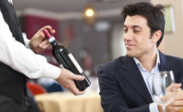 Waiter suggesting a bottle of wine