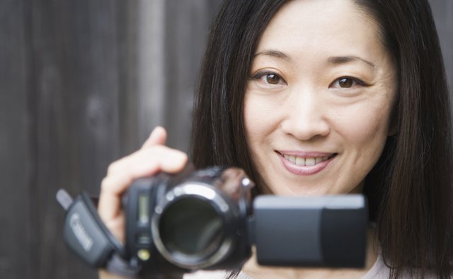 Portrait of a woman holding a home video camera