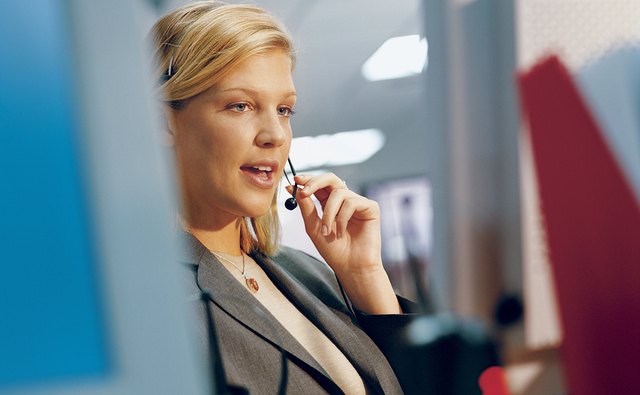 Businesswoman Wearing a Headset and Talking
