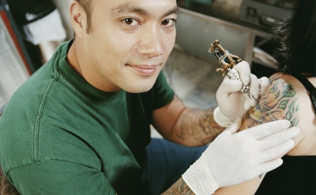 Tattooist Tattooing a Woman's Arm