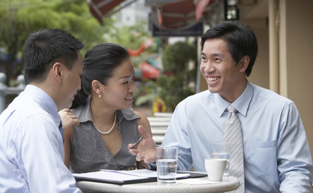 Businesspeople having lunch in outdoors cafe