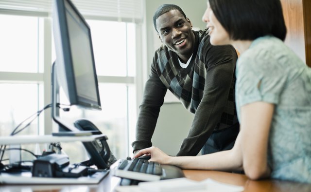 Businesspeople Talking and Using Computer